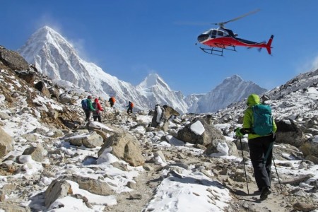 Trekkers and helicopter in Everest region